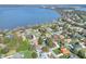Aerial view of home near lake, highlighting its waterfront proximity at 1118 Cypress W Pt, Winter Haven, FL 33884