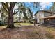 Spacious backyard with mature trees and a playset at 1118 Cypress W Pt, Winter Haven, FL 33884