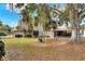 Large backyard with playset, mature trees and screened porch at 1118 Cypress W Pt, Winter Haven, FL 33884
