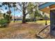 Large backyard with a swing set and mature trees at 1118 Cypress W Pt, Winter Haven, FL 33884