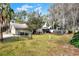 Large backyard with a playset, mature trees, and a fenced area at 1118 Cypress W Pt, Winter Haven, FL 33884
