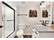 Modern bathroom with white shiplap walls and marble vanity at 1118 Cypress W Pt, Winter Haven, FL 33884