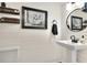 Modern powder room with pedestal sink and shiplap walls at 1118 Cypress W Pt, Winter Haven, FL 33884