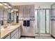 Bathroom with shower, vanity, and nautical-themed walls at 1118 Cypress W Pt, Winter Haven, FL 33884