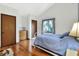 Cozy bedroom with a comfortable bed and hardwood floors at 1118 Cypress W Pt, Winter Haven, FL 33884