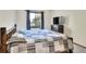 Bedroom with a rustic wooden bed frame and patterned bedding at 1118 Cypress W Pt, Winter Haven, FL 33884