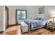 Bright bedroom featuring a bed, window, and hardwood floors at 1118 Cypress W Pt, Winter Haven, FL 33884