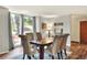 Bright dining room with wood table and chairs, overlooks backyard at 1118 Cypress W Pt, Winter Haven, FL 33884