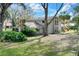 Two-story home with stone accents and a large, grassy yard at 1118 Cypress W Pt, Winter Haven, FL 33884