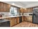 L-shaped kitchen with wood cabinets, stainless steel appliances at 1118 Cypress W Pt, Winter Haven, FL 33884
