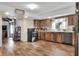Kitchen boasts wood cabinets, stainless steel appliances, and view of fireplace at 1118 Cypress W Pt, Winter Haven, FL 33884