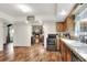 Open kitchen with wood cabinets, stainless steel appliances at 1118 Cypress W Pt, Winter Haven, FL 33884