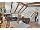 Living room with a stone fireplace, hardwood floors, and access to patio at 1118 Cypress W Pt, Winter Haven, FL 33884