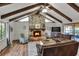Spacious living room with a stone fireplace and hardwood floors at 1118 Cypress W Pt, Winter Haven, FL 33884