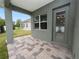 Covered patio with gray door and paver stones at 161 Laynewade Rd, Polk City, FL 33868