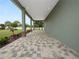 Covered back patio with paver flooring and access to yard at 161 Laynewade Rd, Polk City, FL 33868