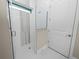 Bright bathroom with a glass-enclosed shower and neutral tile at 161 Laynewade Rd, Polk City, FL 33868