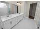 Elegant bathroom featuring double sinks and a walk-in shower at 161 Laynewade Rd, Polk City, FL 33868