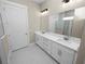 Modern bathroom with double vanity and a large mirror at 161 Laynewade Rd, Polk City, FL 33868
