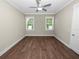 Spacious bedroom with wood floors and ceiling fan at 161 Laynewade Rd, Polk City, FL 33868