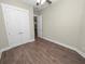 Simple bedroom with wood floors and double doors at 161 Laynewade Rd, Polk City, FL 33868