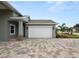 White garage door with paver driveway at 161 Laynewade Rd, Polk City, FL 33868