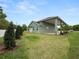 Rear view of house showing covered patio and landscaping at 161 Laynewade Rd, Polk City, FL 33868