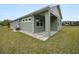 Side view of the house showcasing a covered patio and landscaping at 161 Laynewade Rd, Polk City, FL 33868