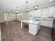 Open concept kitchen with white cabinets, island, and hardwood floors at 161 Laynewade Rd, Polk City, FL 33868