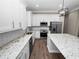 Modern kitchen with white cabinets, granite countertops and stainless steel appliances at 161 Laynewade Rd, Polk City, FL 33868
