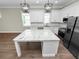 Modern kitchen with white cabinets, granite countertops, and stainless steel appliances at 161 Laynewade Rd, Polk City, FL 33868