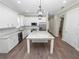 Open concept kitchen with white cabinets, granite countertops, and island at 161 Laynewade Rd, Polk City, FL 33868