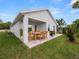 Covered patio with seating area, grill, and lush lawn at 234 Laynewade Rd, Polk City, FL 33868