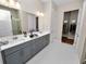 Bathroom boasts double vanity and hexagon tile floors at 234 Laynewade Rd, Polk City, FL 33868