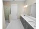 Spa-like bathroom featuring a walk-in shower and double vanity at 234 Laynewade Rd, Polk City, FL 33868