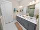 Elegant bathroom with double vanity, large mirror, and hexagon tile floor at 234 Laynewade Rd, Polk City, FL 33868