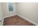 Small bedroom with wood flooring and a window at 234 Laynewade Rd, Polk City, FL 33868