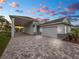 Single-story home with attached garage and paver driveway at 234 Laynewade Rd, Polk City, FL 33868