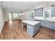 Modern kitchen with gray cabinets, granite island, and stainless steel appliances at 234 Laynewade Rd, Polk City, FL 33868