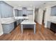 Modern kitchen with gray cabinets, granite island, and stainless steel appliances at 234 Laynewade Rd, Polk City, FL 33868