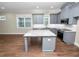 Modern kitchen with gray cabinets, granite island, and stainless steel appliances at 234 Laynewade Rd, Polk City, FL 33868