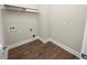 Laundry room with wood flooring and shelving at 234 Laynewade Rd, Polk City, FL 33868