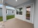 Covered patio with access door to backyard at 234 Laynewade Rd, Polk City, FL 33868