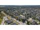 Neighborhood aerial showcasing proximity to amenities and tree-lined streets at 252 Magneta Loop, Auburndale, FL 33823