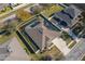 House with solar panels and a screened-in pool, seen from an aerial perspective at 252 Magneta Loop, Auburndale, FL 33823