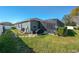 Landscaped backyard with screened patio and grilling area at 252 Magneta Loop, Auburndale, FL 33823