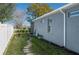 Well-maintained backyard featuring a stone pathway and white picket fence at 252 Magneta Loop, Auburndale, FL 33823