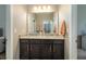 Double vanity bathroom with granite countertops and dark wood cabinets at 252 Magneta Loop, Auburndale, FL 33823