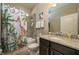 Bathroom with shower/tub combo, granite vanity and fun shower curtain at 252 Magneta Loop, Auburndale, FL 33823