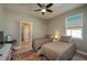 Bedroom with twin beds, ceiling fan and access to a full bath at 252 Magneta Loop, Auburndale, FL 33823